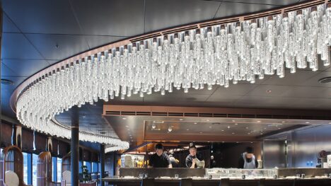 A white curved light display in a modern cruise ship restaurant