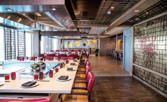 teppanyaki restaurant on board odyssey of the seas featuring a neutral colour scheme with hints of red