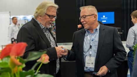two cruise ship interiors expo attendees exchanging business cards